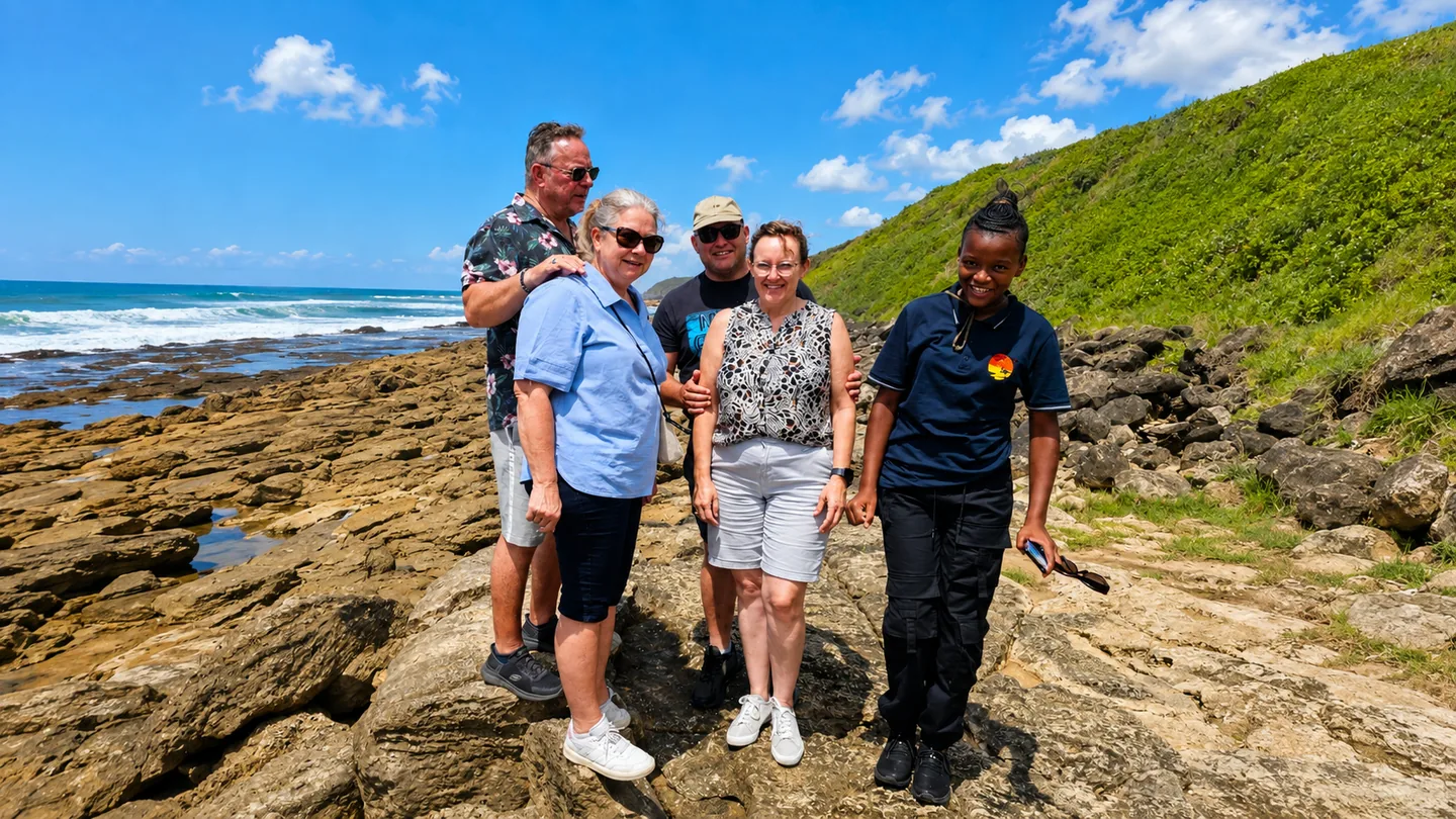 Tour group exploring a rocky coastal landscape