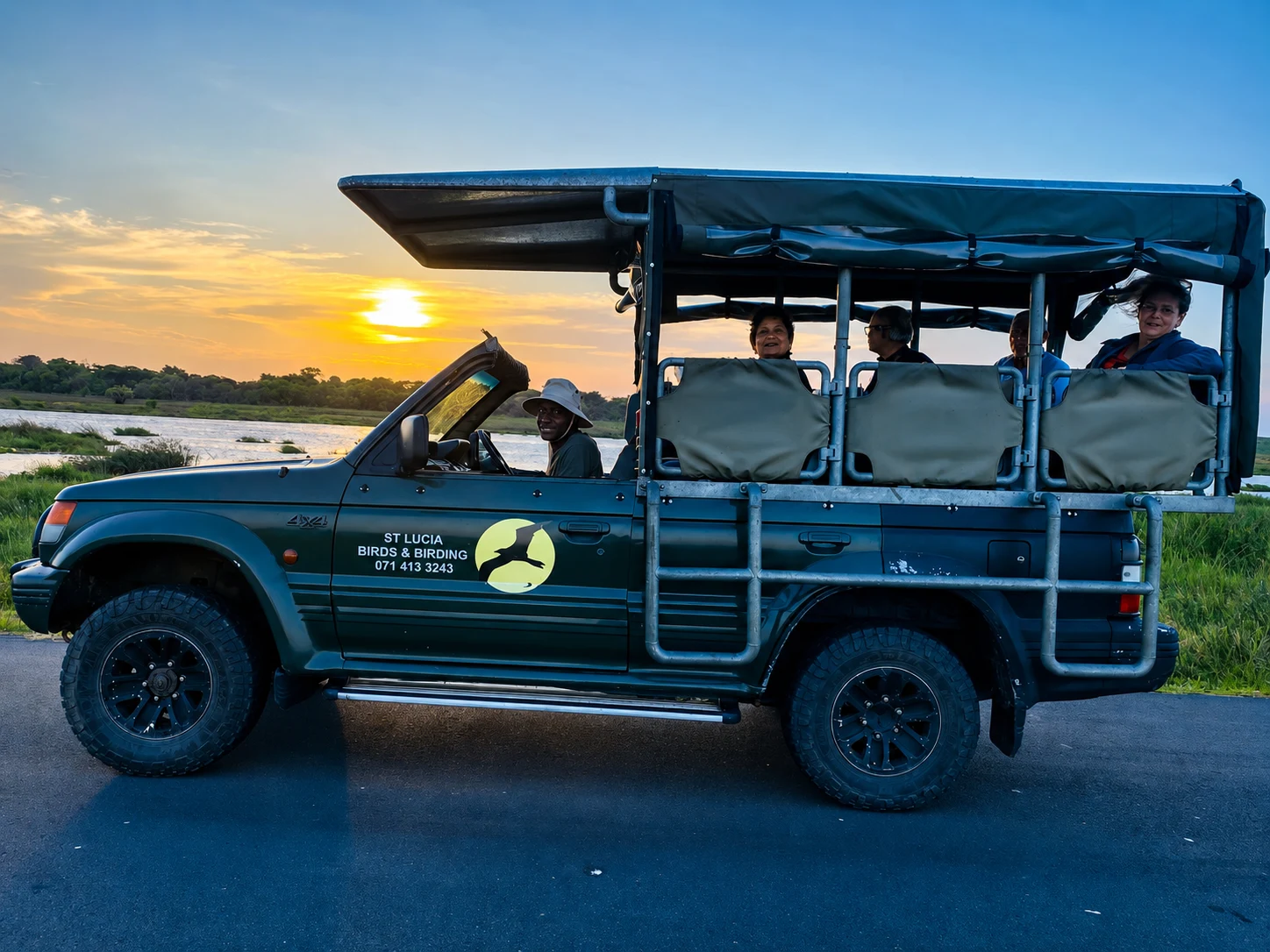 Guests travelling in a birding safari vehicle at sunset